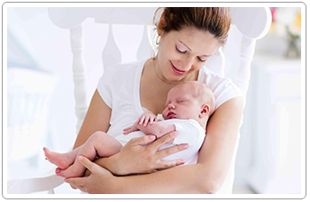 A mother holding her newborn child
